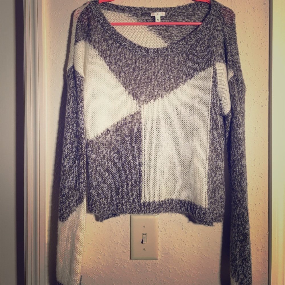 Grey and white knit sweater with open sides